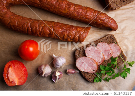 Slices of smoked sausage with spice, herbs and 61343137