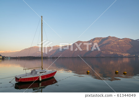 wonderful red boat on stunning mountain Iseo lake wonderful red boat on stunning mountain Iseo lake 61344049