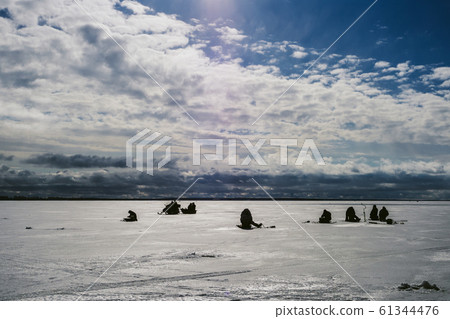 silhouettes of fishermen fishing and snowmobile in winter on the ice silhouettes of fishermen fishing and snowmobile in winter on the ice 61344476