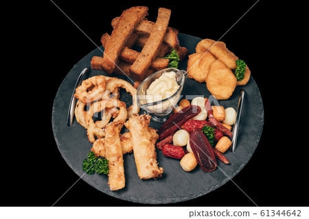 set of snacks for beer from crackers, onion rings, sausage and cheese set of snacks for beer from crackers, onion rings, sausage and cheese 61344642