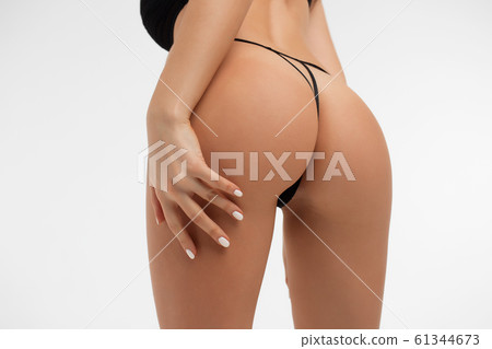 Young lady in lace lingerie leaving buttocks bare Young lady in lace lingerie leaving buttocks bare 61344673
