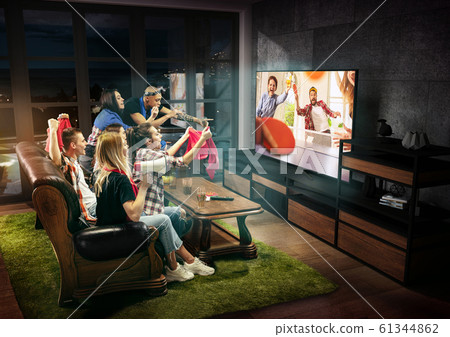Group of friends watching TV, sport concept, leisure activity 61344862