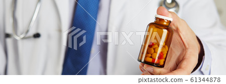 Male medicine doctor hand holding and offering to patient jar of pills Male medicine doctor hand holding and offering to patient jar of pills 61344878