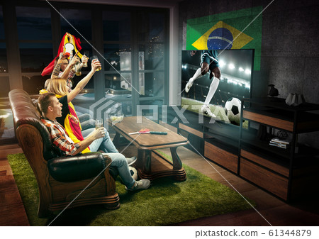 Group of friends watching TV, sport concept, leisure activity Group of friends watching TV, sport concept, leisure activity 61344879