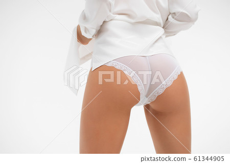 Faceless graceful woman with hands on buttock 61344905