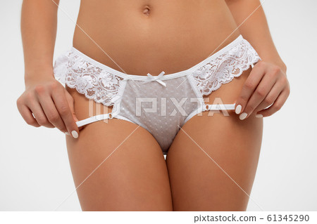 Faceless seductive female touching lingerie in Stock Photo