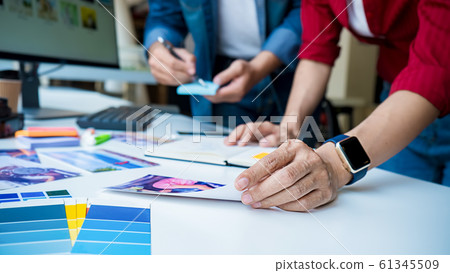 Advertising agency designer creative start-up team discussing ideas in office. Advertising agency designer creative start-up team discussing ideas in office. 61345509