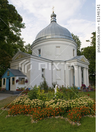 White church with flowers in foreground 61346141