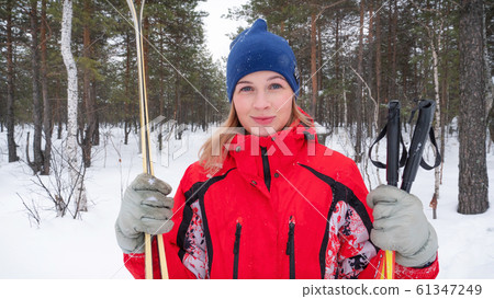 Happy young sportswoman ready for ski race in winter day Happy young sportswoman ready for ski race in winter day 61347249