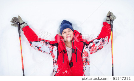 Cheerful young female skier enjoying winter in daytime Cheerful young female skier enjoying winter in daytime 61347251
