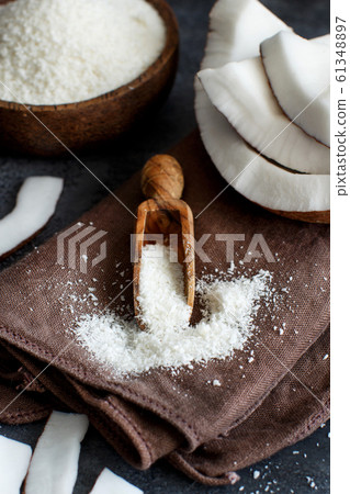 Coconut flour in a wooden spoon close up Coconut flour in a wooden spoon close up 61348897
