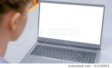 Grey laptop with white blank screen on table in cafe interior Grey laptop with white blank screen on table in cafe interior 61349954