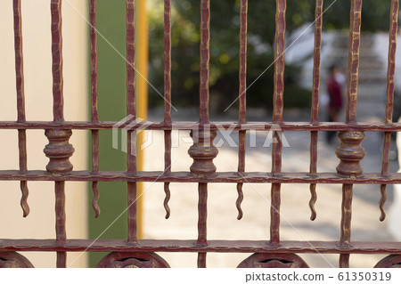 Wrought iron tracery brown fence fragment . 61350319