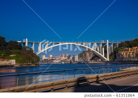 View of the Douro River and the Arrabida Bridge in a beautiful early spring day at Porto City in Portugal View of the Douro River and the Arrabida Bridge in a beautiful early spring day at Porto City in Portugal 61351864