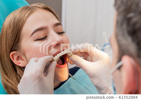 doctor tries on a denture 61352004