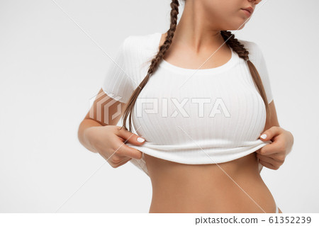 Crop sensual young lady taking off shirt 61352239