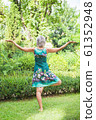 The back view, the girl practicing yoga and practicing yoga postures, amazing yoga postures in grass 61352948