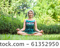 the girl practicing yoga and practicing yoga postures, amazing yoga postures in grass 61352950