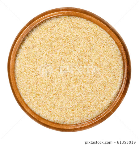 Dried garlic granules in wooden bowl 61353019