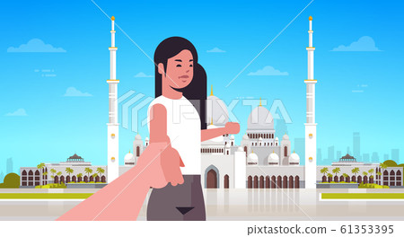 travelers taking follow me photo on background of nabawi mosque building live streaming traveling blogging concept tourists sightseeing muslim cityscape horizontal portrait 61353395