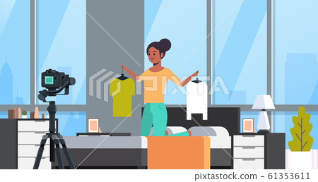 fashion blogger holding hangers with clothes african american woman recording online video live streaming social media blogging concept modern bedroom interior portrait horizontal fashion blogger holding hangers with clothes african american woman recording online video live streaming social media blogging concept modern bedroom interior portrait horizontal 61353611