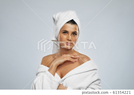 Woman posing in bathrobe after shower. Woman posing in bathrobe after shower. 61354221