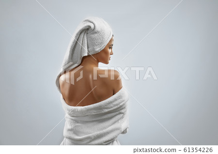 Back view of woman in bathrobe and towel. Back view of woman in bathrobe and towel. 61354226