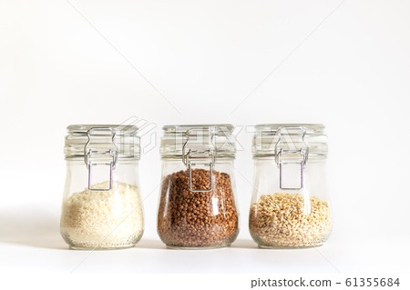 Rice, buckwheat and pearl barley are tightly closed in a glass bowl. Cereals are stored in banks. Healthy food for vegetarianism and other diets. Safe and environmentally friendly food storage 61355684