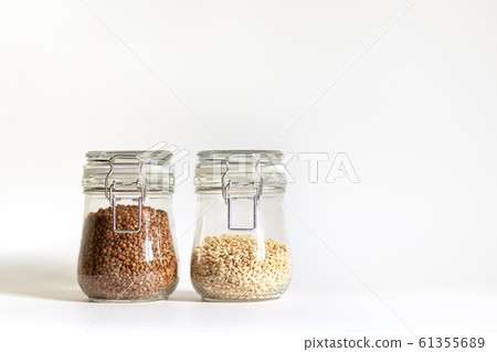 Buckwheat and pearl barley are tightly closed in a glass container. Cereals are stored in banks. Healthy food for vegetarianism and other diets. Safe and environmentally friendly food storage 61355689