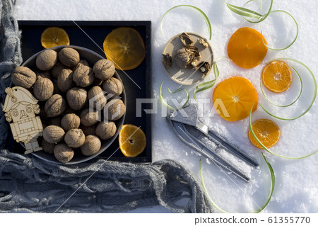 winter flat lay with walnut on black tray, winter flat lay with walnut on black tray, 61355770