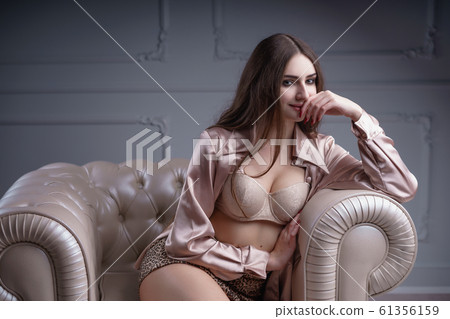 Beautiful woman with long hair sensual beige lingerie studio photoshoot Beautiful woman with long hair sensual beige lingerie studio photoshoot 61356159