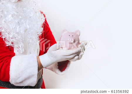 piggy bank in hands of Santa Claus on a white background 61356392
