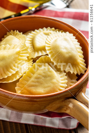Italian stuffed pasta. Panzerotti pasta in bowl Italian stuffed pasta. Panzerotti pasta in bowl 61356641