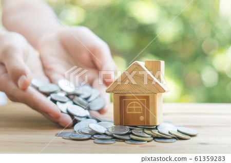 House placed on coins Men's hand is planning House placed on coins Men's hand is planning 61359283