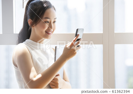 Business woman with a smartphone Business woman with a smartphone 61362394