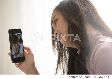 Couple making videophone call 61362431