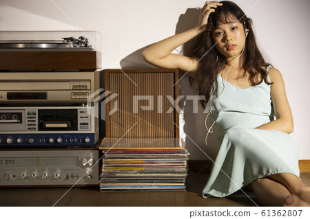 A woman dusk listening to music 61362807