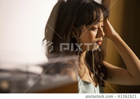 A woman dusk listening to music A woman dusk listening to music 61362821