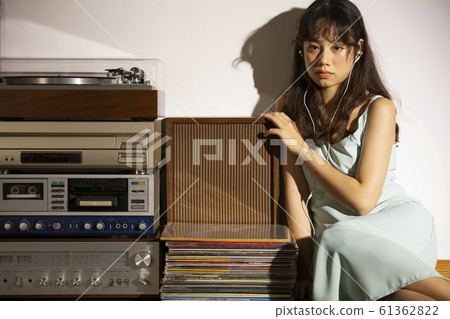 A woman dusk listening to music A woman dusk listening to music 61362822