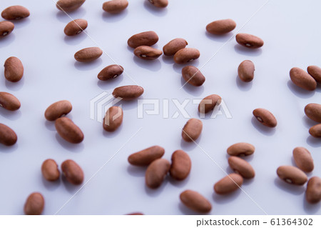 Scattered brown beans. Scattered brown beans. 61364302