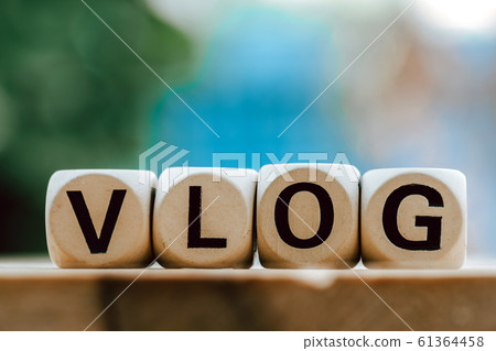 VLOG concept with wooden block on wooden table VLOG concept with wooden block on wooden table 61364458