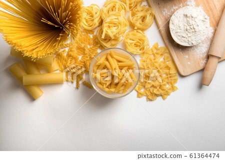 Different kinds of pasta on a white background 61364474