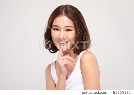 Beautiful Asian young woman touching soft cheek smile with clean and fresh skin Happiness and cheerful with positive emotional,isolated on gray background,Beauty and Cosmetics Concept Beautiful Asian young woman touching soft cheek smile with clean and fresh skin Happiness and cheerful with positive emotional,isolated on gray background,Beauty and Cosmetics Concept 61365182