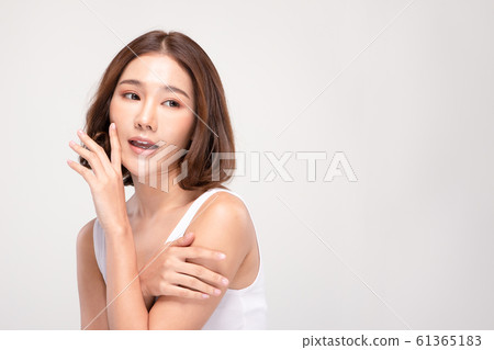 Beautiful Asian young woman touching soft cheek smile with clean and fresh skin Happiness and cheerful with positive emotional,isolated on gray background,Beauty and Cosmetics Concept Beautiful Asian young woman touching soft cheek smile with clean and fresh skin Happiness and cheerful with positive emotional,isolated on gray background,Beauty and Cosmetics Concept 61365183