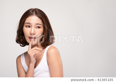 Beautiful Asian young woman touching soft cheek smile with clean and fresh skin Happiness and cheerful with positive emotional,isolated on gray background,Beauty and Cosmetics Concept Beautiful Asian young woman touching soft cheek smile with clean and fresh skin Happiness and cheerful with positive emotional,isolated on gray background,Beauty and Cosmetics Concept 61365185