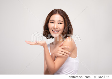 Beautiful Asian young woman touching soft cheek smile with clean and fresh skin Happiness and cheerful with positive emotional,isolated on gray background,Beauty and Cosmetics Concept Beautiful Asian young woman touching soft cheek smile with clean and fresh skin Happiness and cheerful with positive emotional,isolated on gray background,Beauty and Cosmetics Concept 61365186
