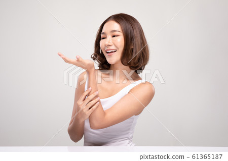 Beautiful Asian young woman touching soft cheek smile with clean and fresh skin Happiness and cheerful with positive emotional,isolated on gray background,Beauty and Cosmetics Concept Beautiful Asian young woman touching soft cheek smile with clean and fresh skin Happiness and cheerful with positive emotional,isolated on gray background,Beauty and Cosmetics Concept 61365187