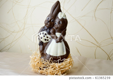 Two chocolate rabbits. Two tasty, embracing 61365239