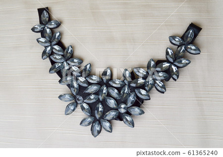 A female triangle-shaped necklace decorated  61365240