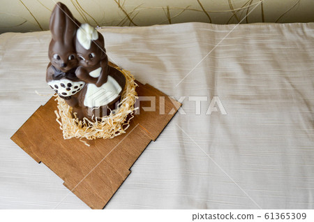 Two chocolate rabbits. Two tasty, embracing 61365309